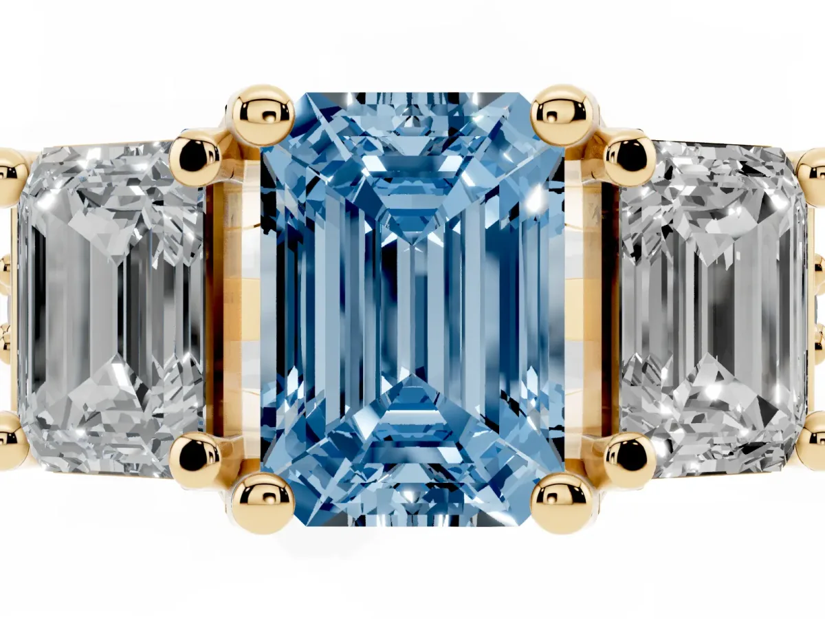 Fancy Blue Emerald Cut Diamond Three-Stone Ring with Channel Set Band and Four-Prong Setting Yellow gold