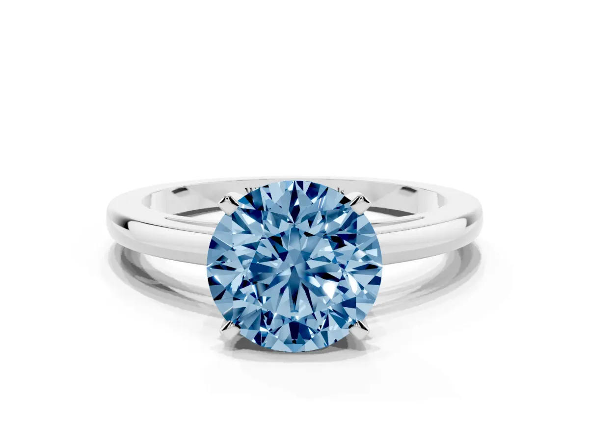 Fancy Blue Round Cut Solitaire Diamond Engagement Ring with Four-Prong Setting on a Classic Band Silver