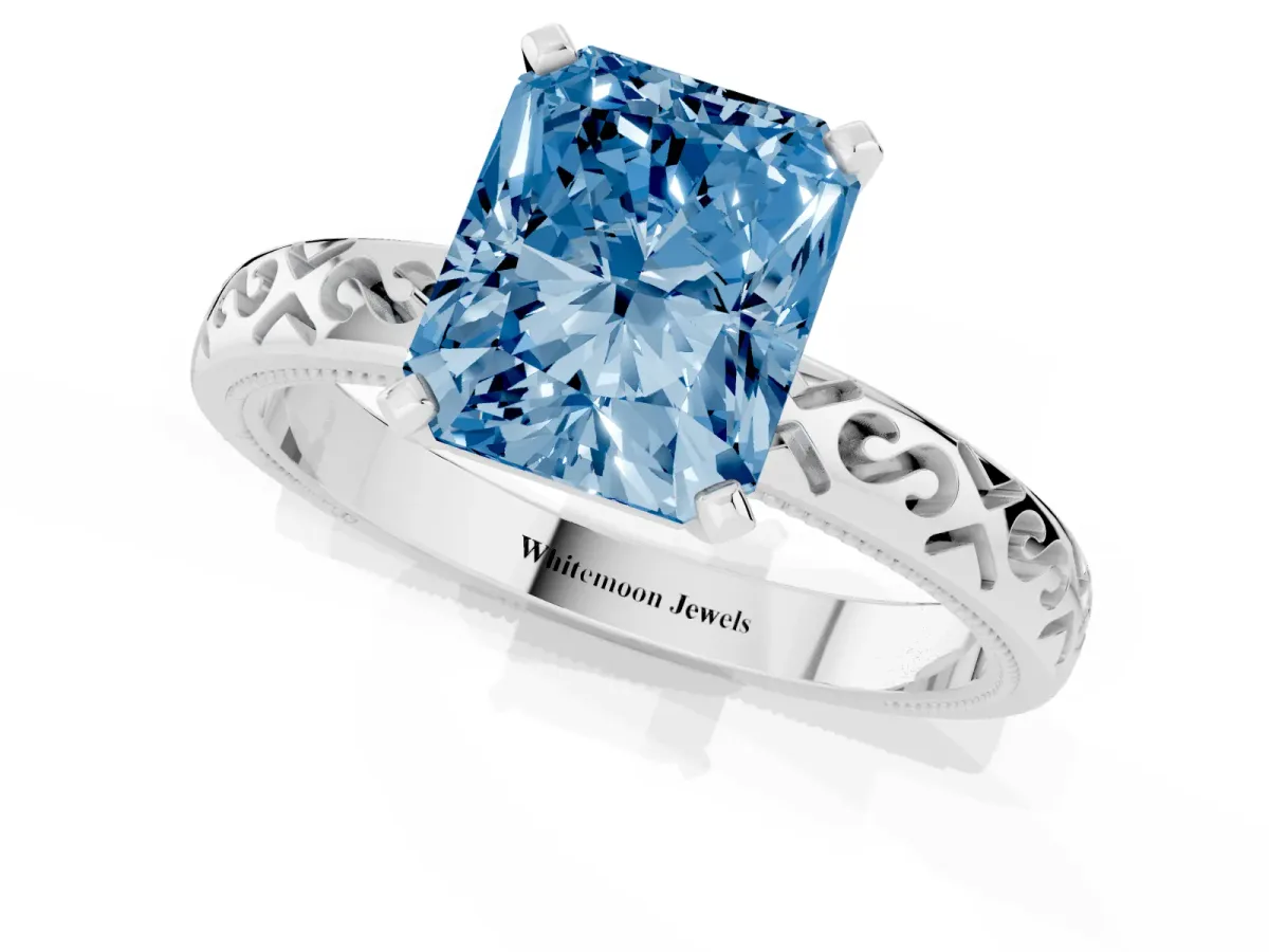 Fancy Blue Radiant Cut Solitaire Engagement Ring with Scrollwork Band and Four-Prong Setting Silver