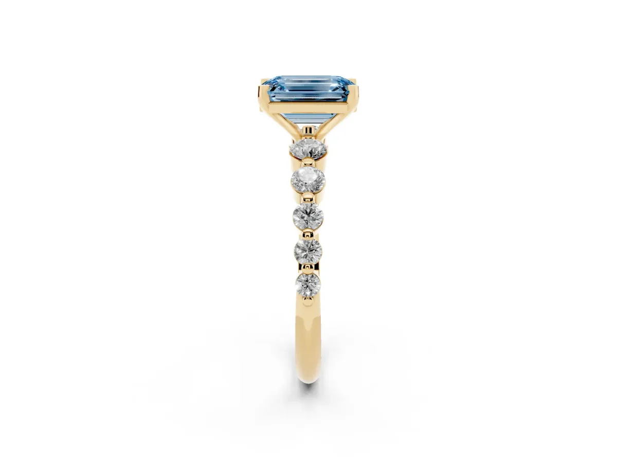 Fancy Blue Emerald Cut Solitaire Diamond Ring with Pave Band and Four-Prong Setting Yellow gold