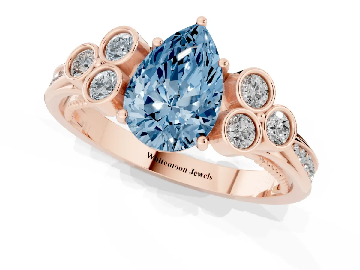 Fancy Blue Pear Cut Cut Diamond Engagement Ring with Bezel Set Round Side Stones and Prong Setting Rose gold