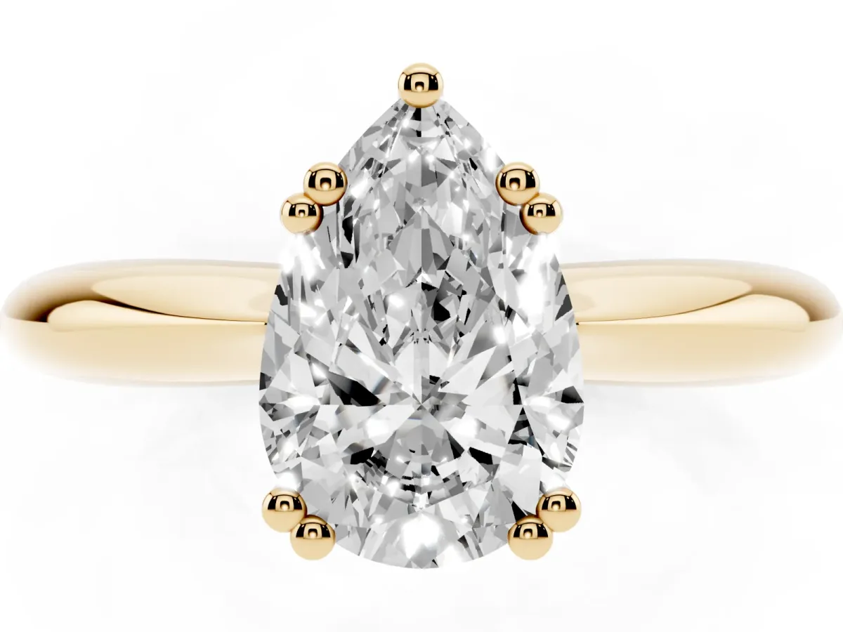 Pear Cut Cut Solitaire Engagement Ring with Tapered Band and Four-Prong Setting Yellow gold