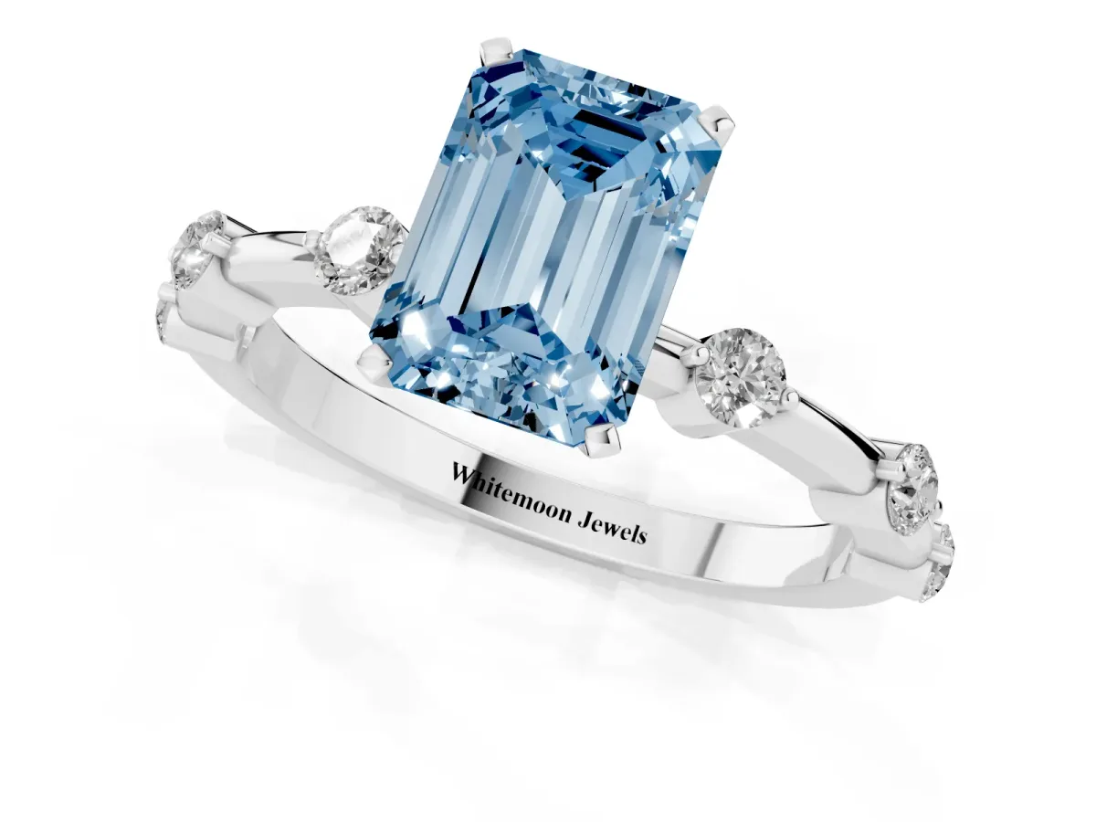 Fancy Blue Emerald Cut Solitaire Diamond Ring with Bezel Set Side Stones and Prong Setting Silver