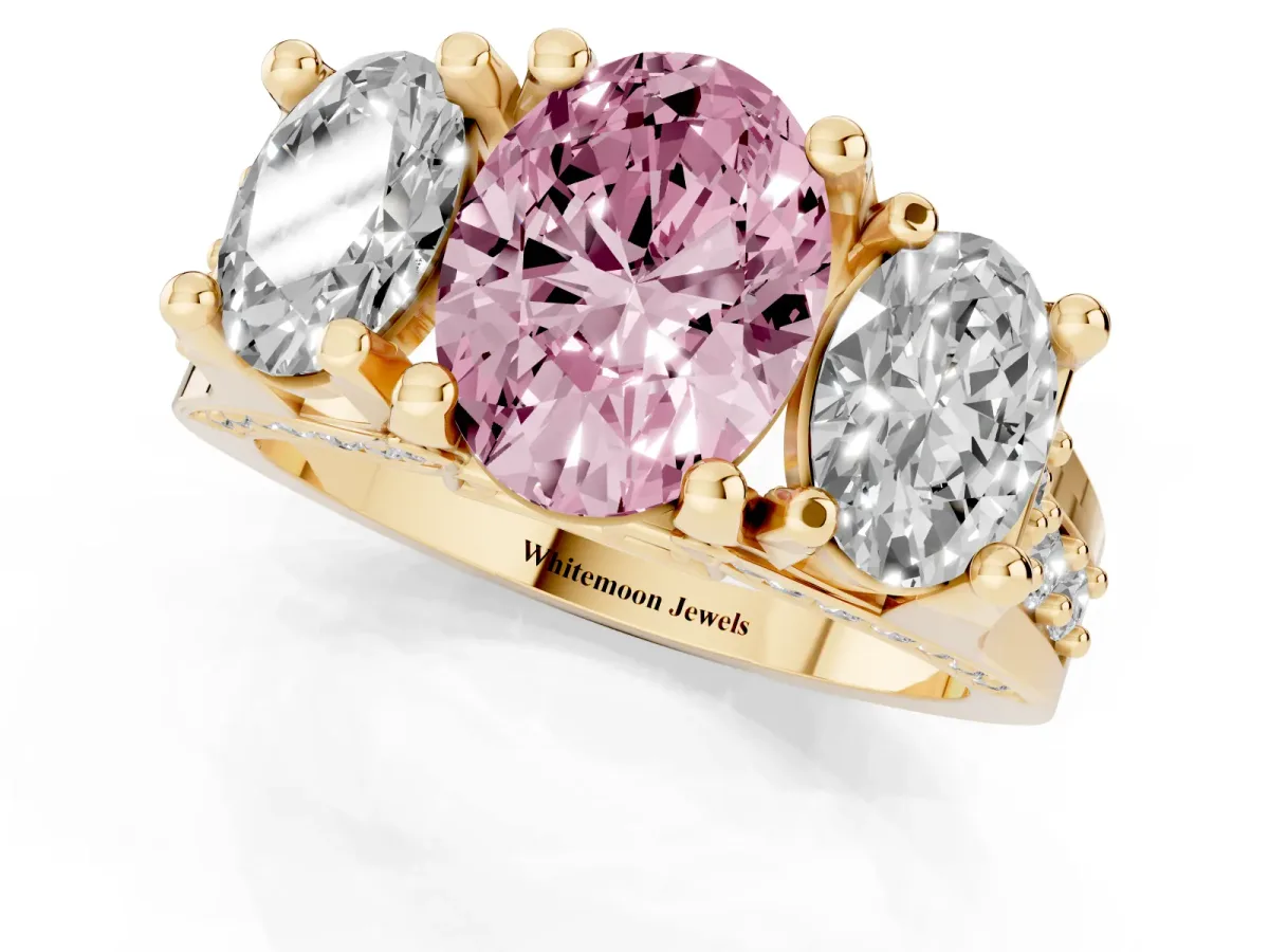 Fancy Pink Oval Cut Diamond Three-Stone Ring with Channel Set Band and Four-Prong Setting Yellow gold