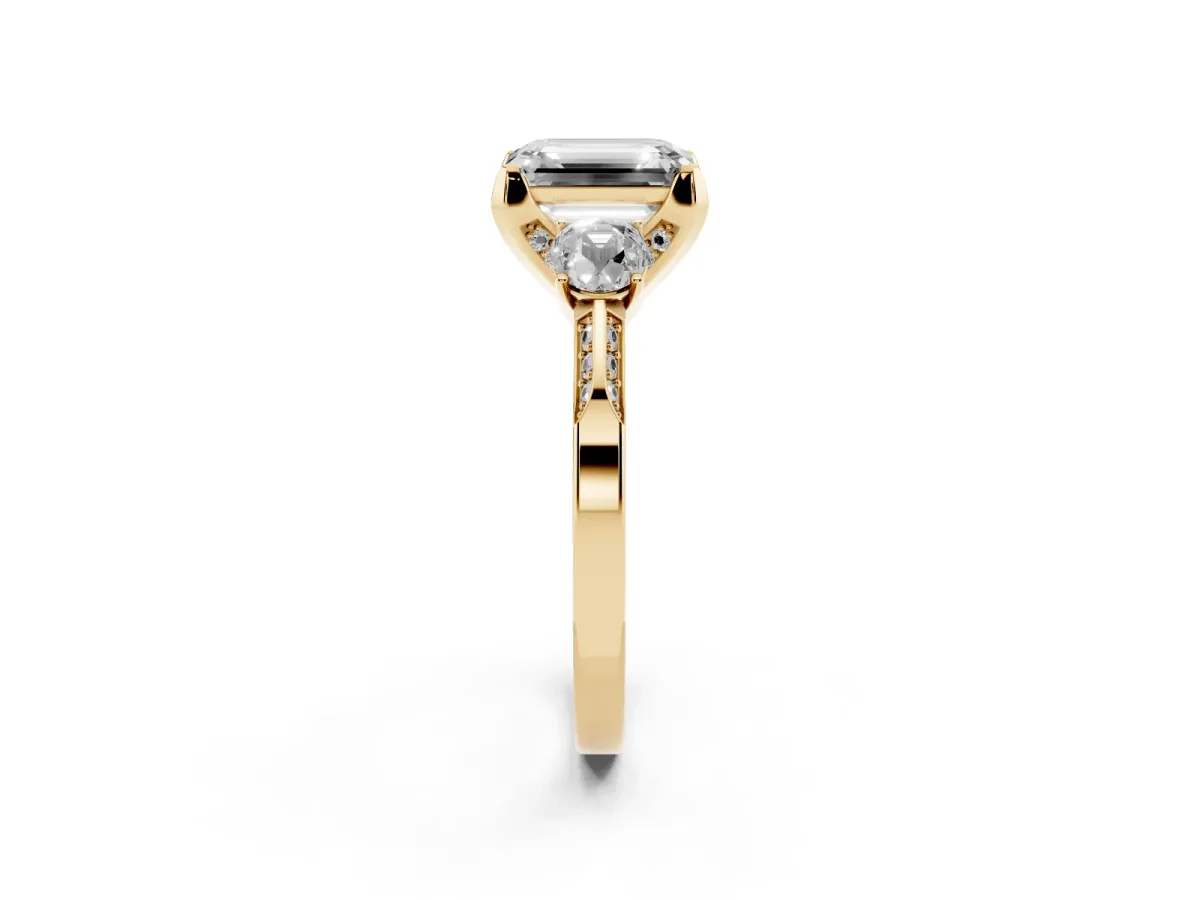 Emerald Cut Brilliant Three-Stone Diamond Ring with Pavé Band and Four-Prong Setting Yellow gold