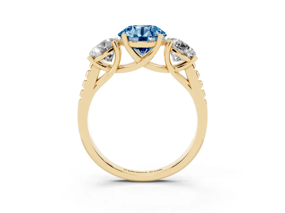 Fancy Blue Three-Stone Round Cut Diamond Ring with Round Pavé Band and Prong Setting Yellow gold