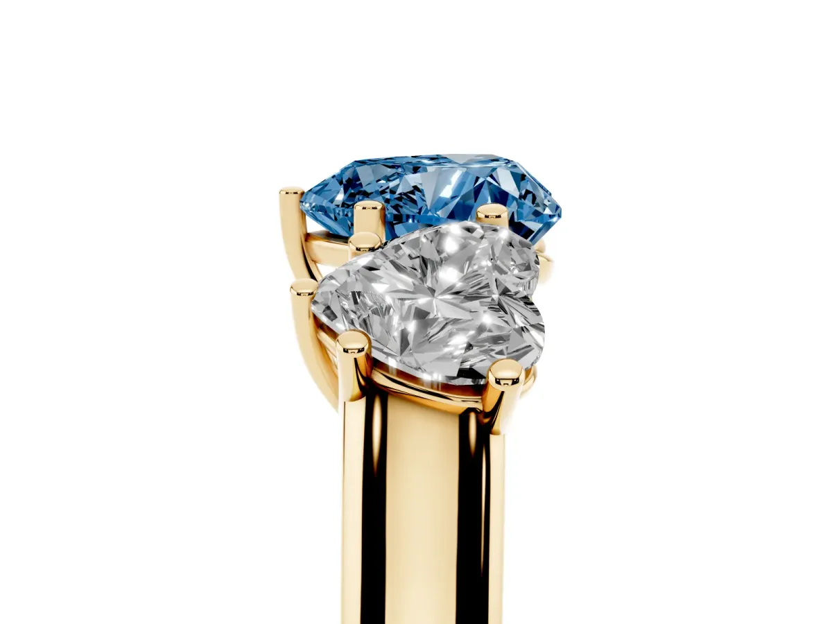 Fancy Blue Heart Cut Three-Stone Diamond Ring with Prong Setting on a Classic Band Yellow gold