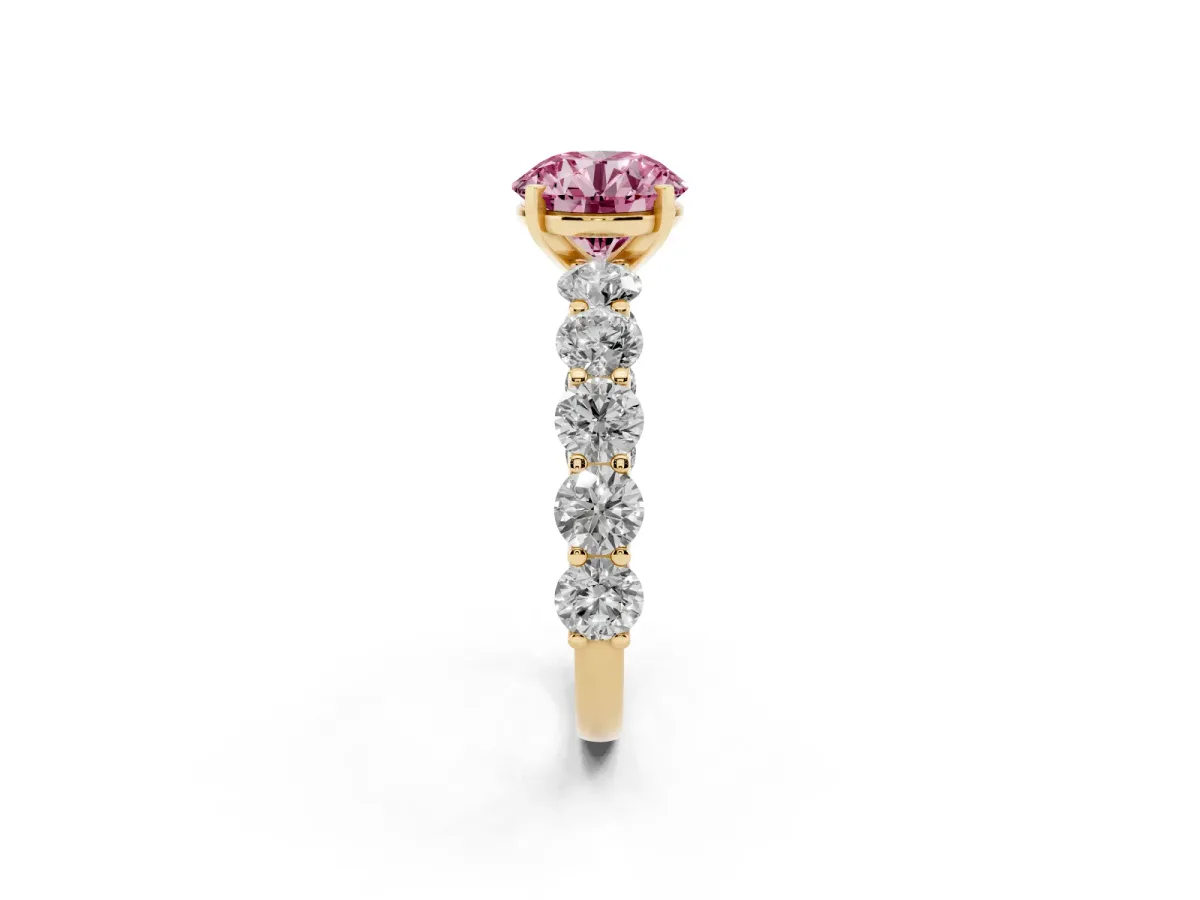 Fancy Pink Round Cut Diamond Prong Setting with Side Stones on a Pave Band Yellow gold