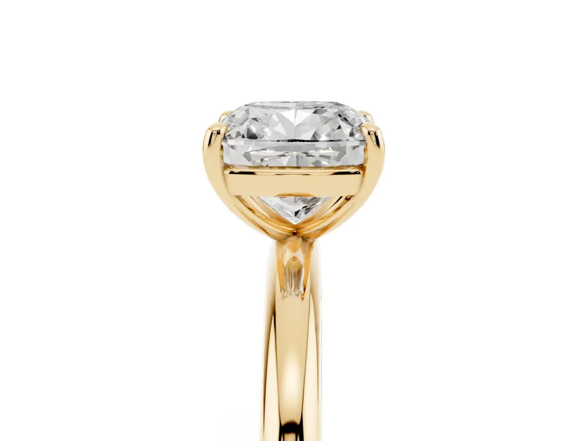 Cushion Cut Solitaire Diamond Ring with Four-Prong Setting on a Plain Band Yellow gold