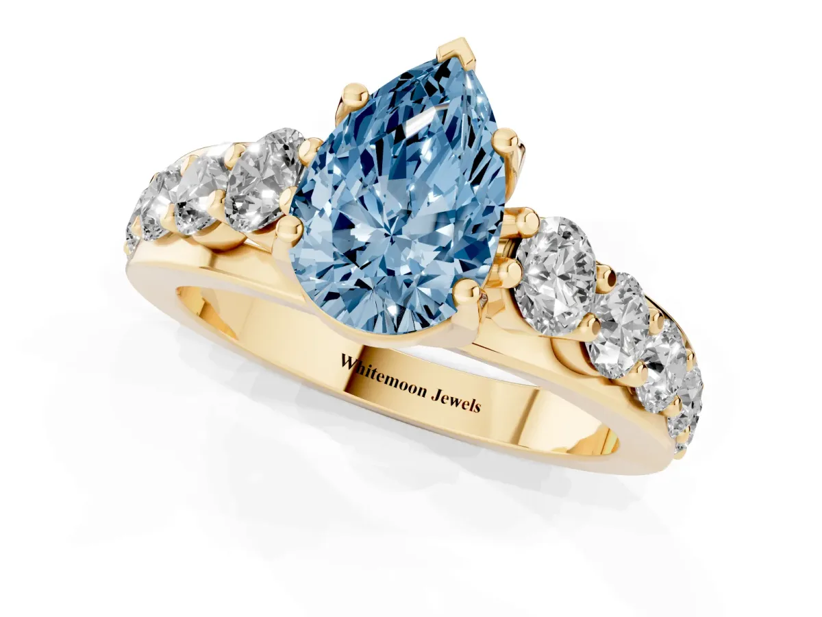 Fancy Blue Pear Cut Diamond Engagement Ring with Pavé Band and Four-Prong Setting Yellow gold