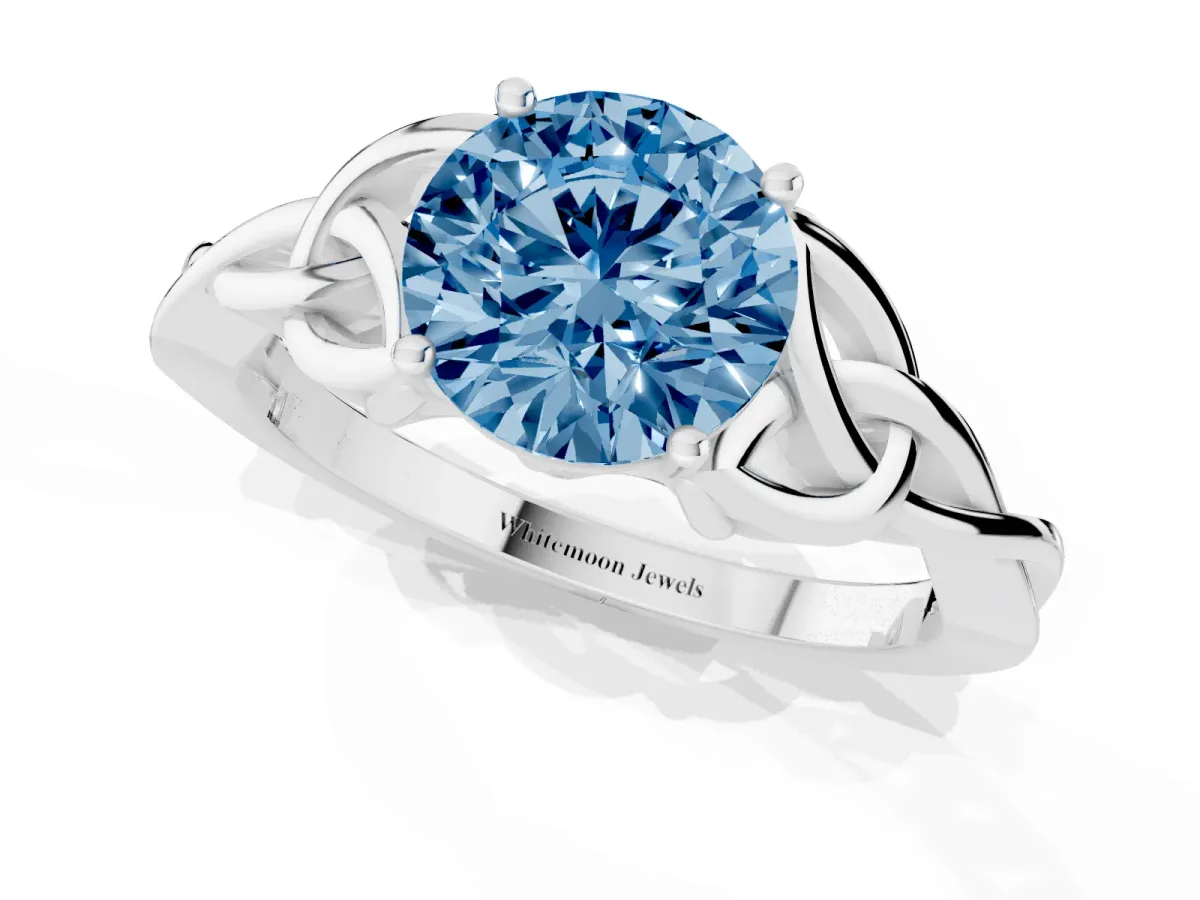 Fancy Blue Round Cut Diamond Solitaire Engagement Ring with Celtic Knot Band and Four-Prong Setting Silver