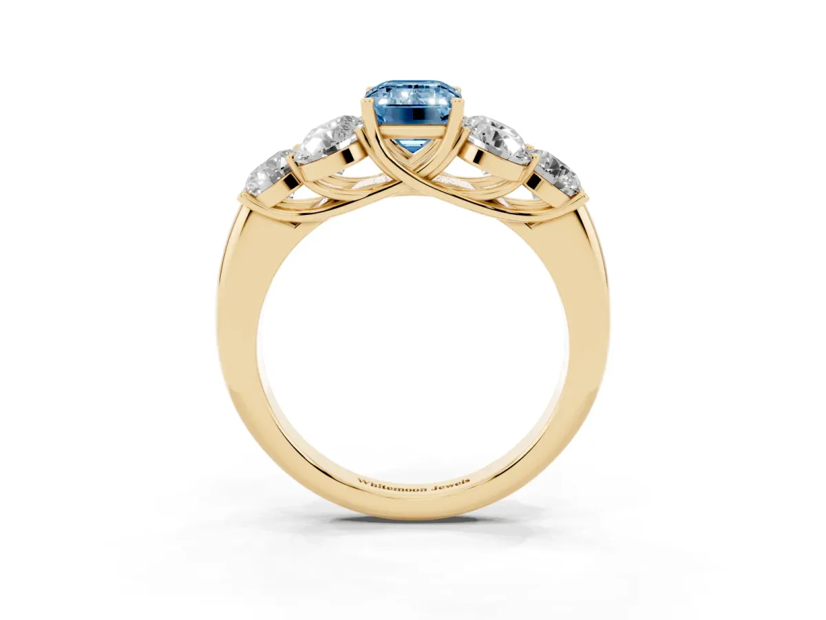 Fancy Blue Emerald Cut Cut Diamond Cluster Ring with Round Accent Stones and Prong Setting on a Classic Band Yellow gold