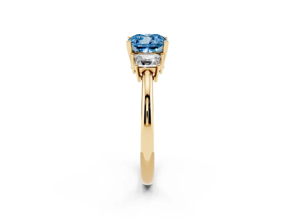Fancy Blue Cushion Cut Diamond Three-Stone Ring with Trapezoid Side Stones and Prong Setting Yellow gold