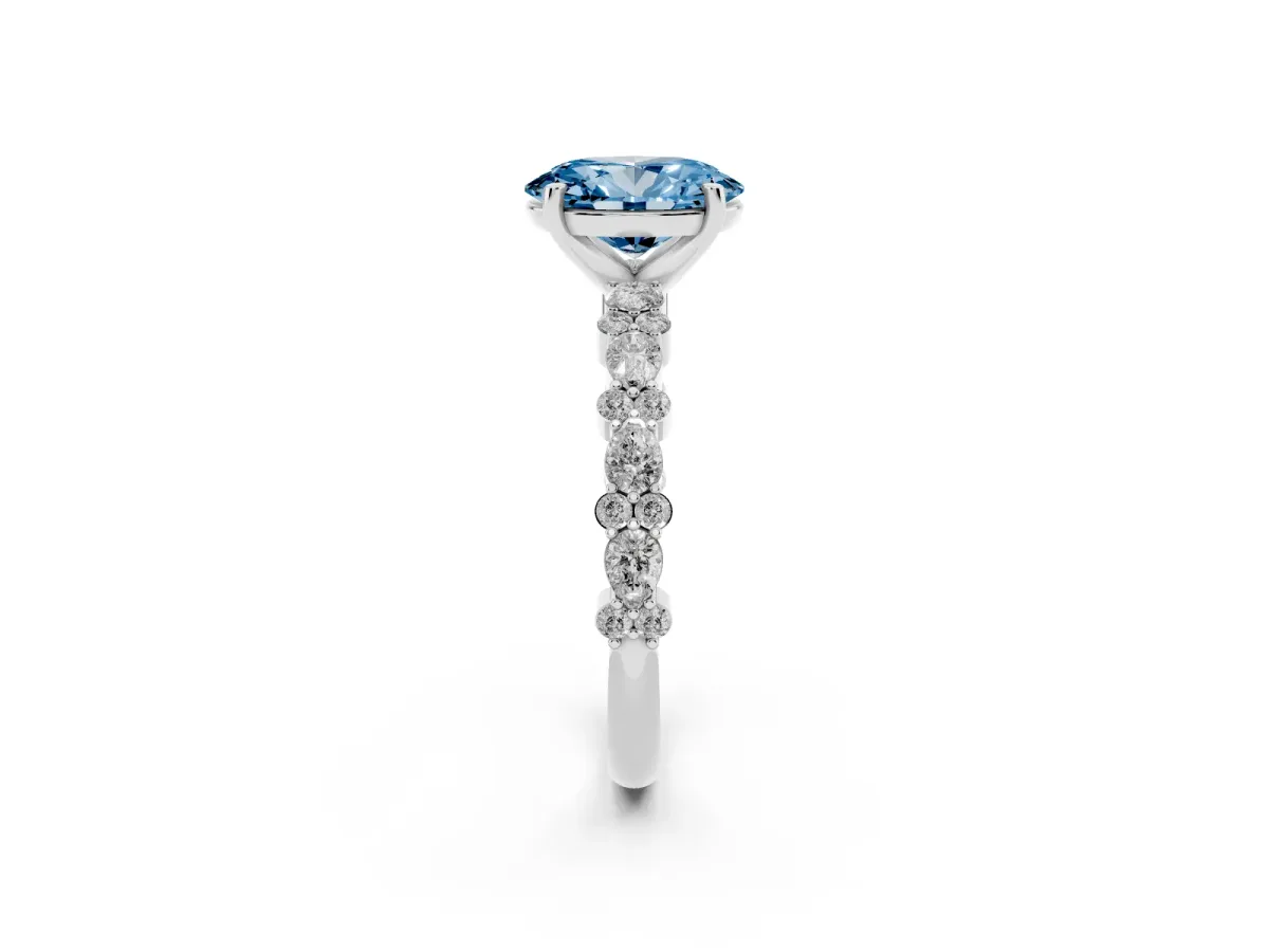 Fancy Blue Oval Cut Diamond Side Stone Solitaire Ring with Round and Four-Prong Setting Silver