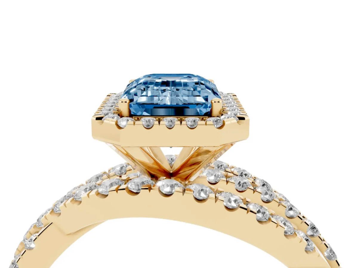 Fancy Blue Emerald Cut Diamond Halo Ring with Round Split Shank and Prong Setting Yellow gold