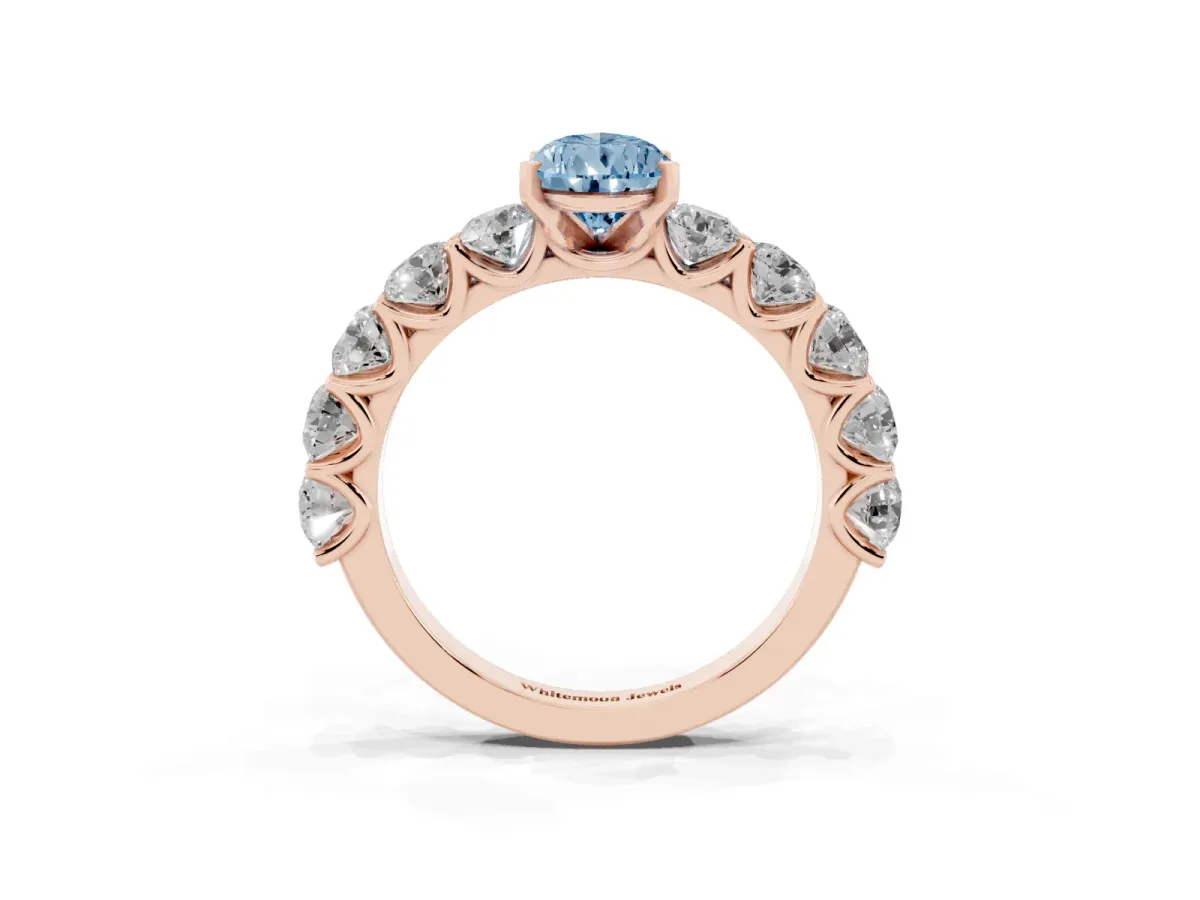 Fancy Blue Pear Cut Diamond Prong Setting with Side Stones on a Pave Band Rose gold