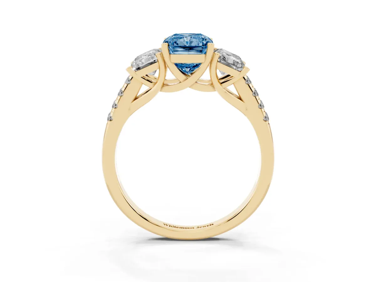 Fancy Blue Three-Stone Radiant Cut Diamond Ring with Round Pavé Band and Prong Setting Yellow gold