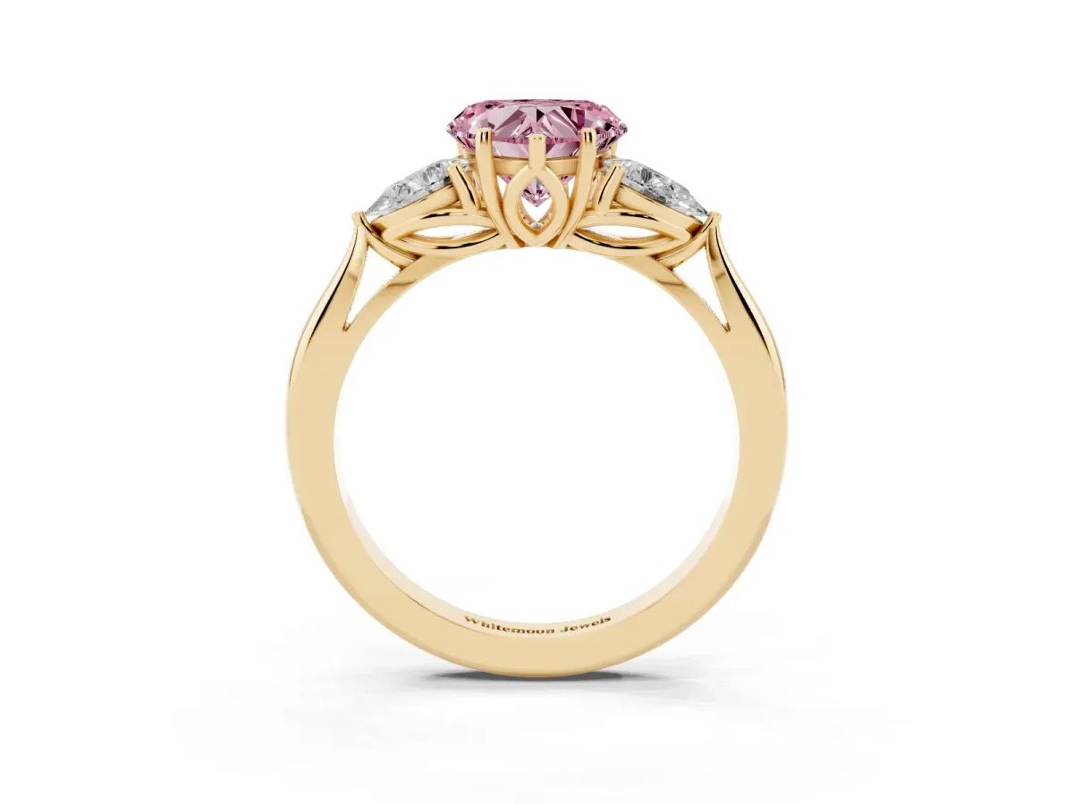 Fancy Pink Three-Stone Heart Cut Brilliant Diamond Solitaire Ring with Tapered Band and Four-Prong Setting Yellow gold