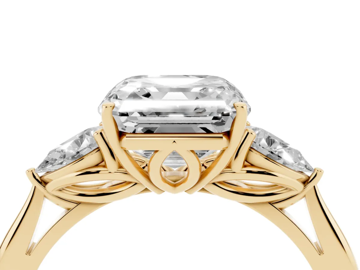 Three-Stone Asscher Cut Diamond Ring with Pear Side Stones in Four-Prong Setting Yellow gold