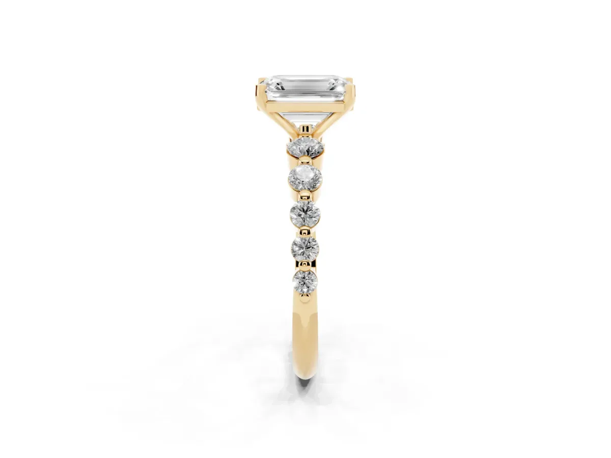Emerald Cut Solitaire Diamond Ring with Pave Band and Four-Prong Setting Yellow gold