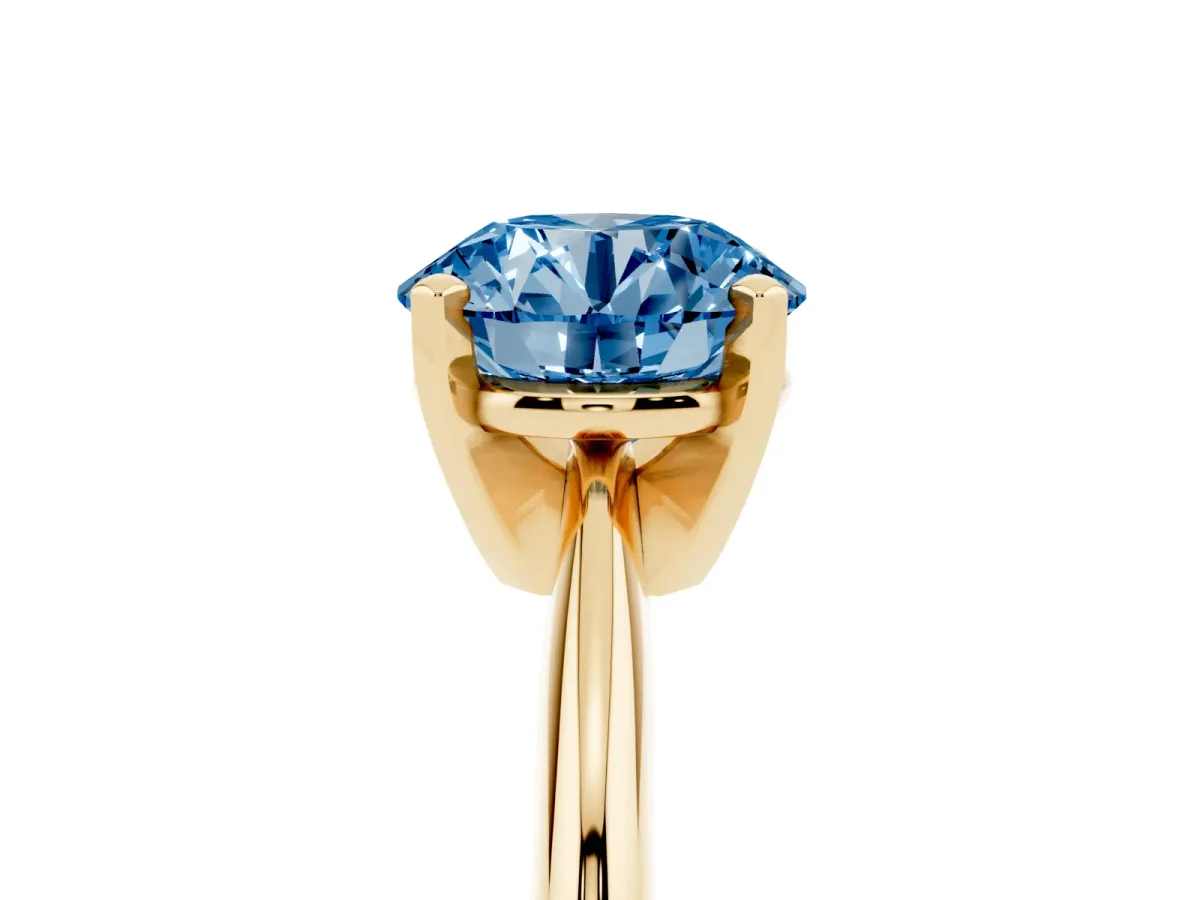 Fancy Blue Round Cut Cut Solitaire Ring with Four-Prong Setting on a Classic Band Yellow gold