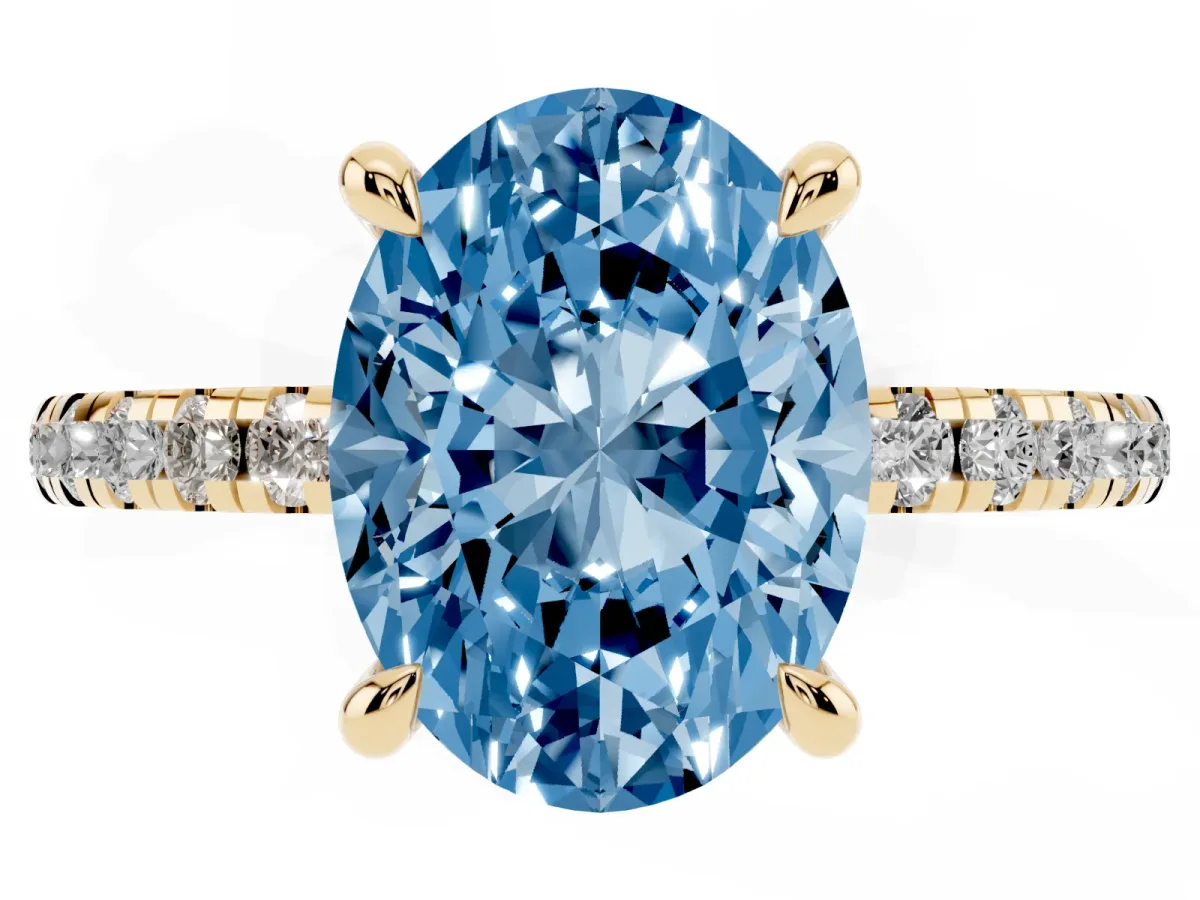Fancy Blue Oval Cut Diamond Brilliant Solitaire Ring with Pavé Band and Four-Prong Setting Yellow gold