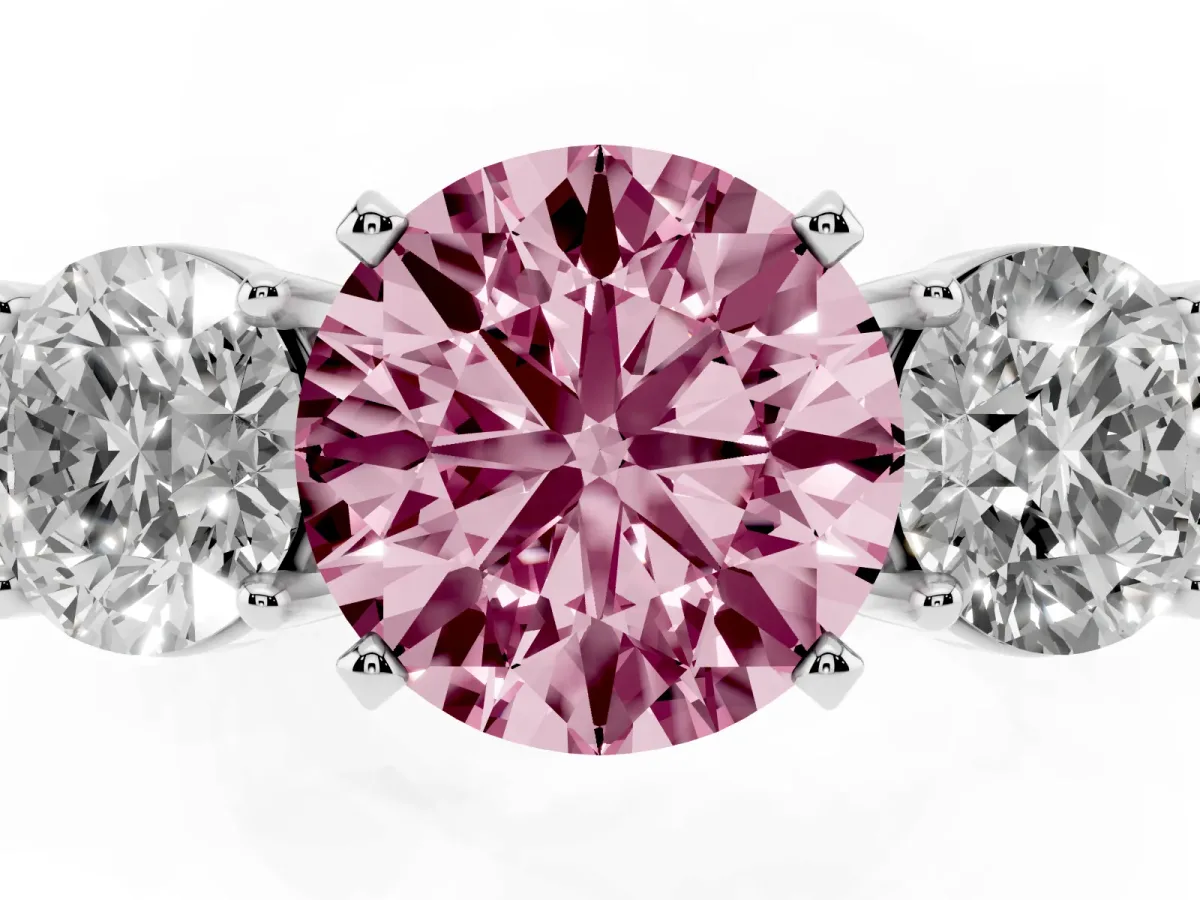 Fancy Pink Three-Stone Round Cut Diamond Ring with Round Side Stones, Classic Band, and Four-Prong Setting Platinum