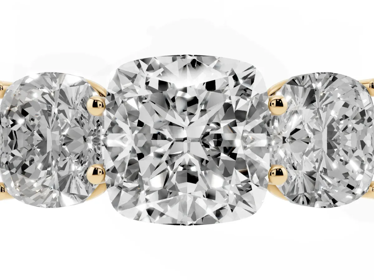 Cushion Cut Three-Stone Diamond Ring with Prong Setting on a Classic Band Yellow gold