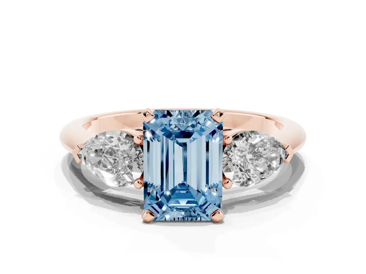Fancy Blue Three-Stone Emerald Cut Diamond Ring with Pear Side Stones and Four-Prong Setting Rose gold