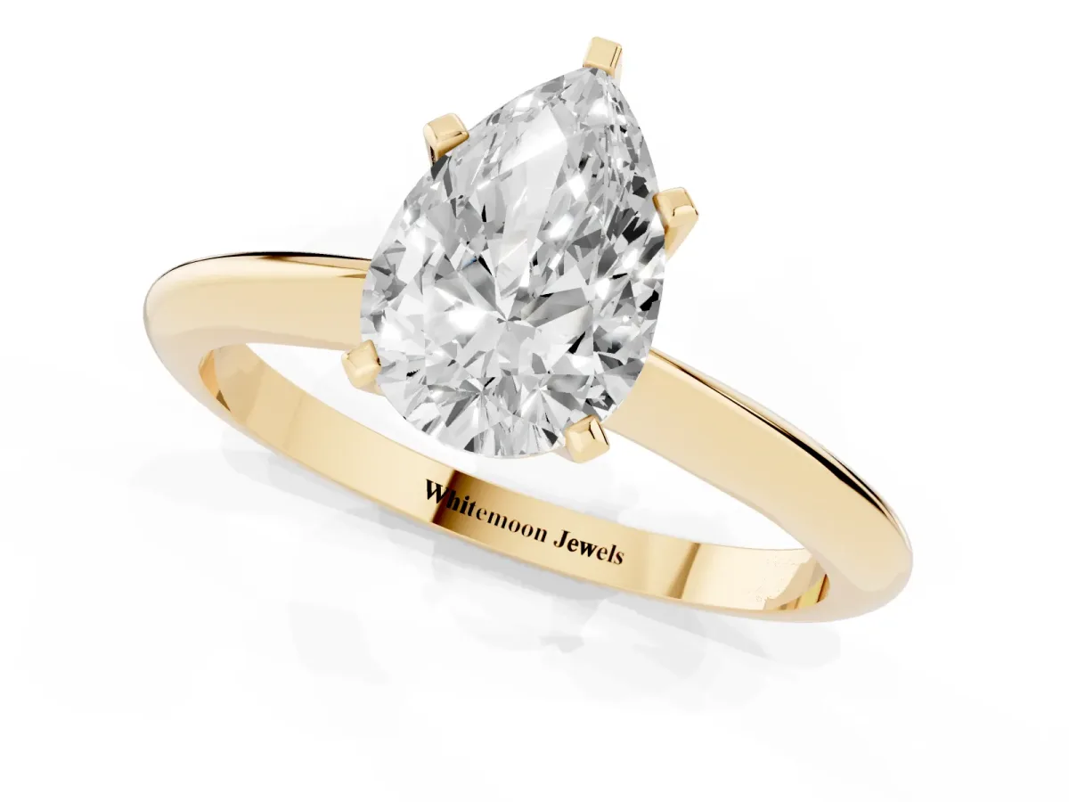 Pear Cut Cut Solitaire Ring with Four-Prong Setting on a Classic Band Yellow gold