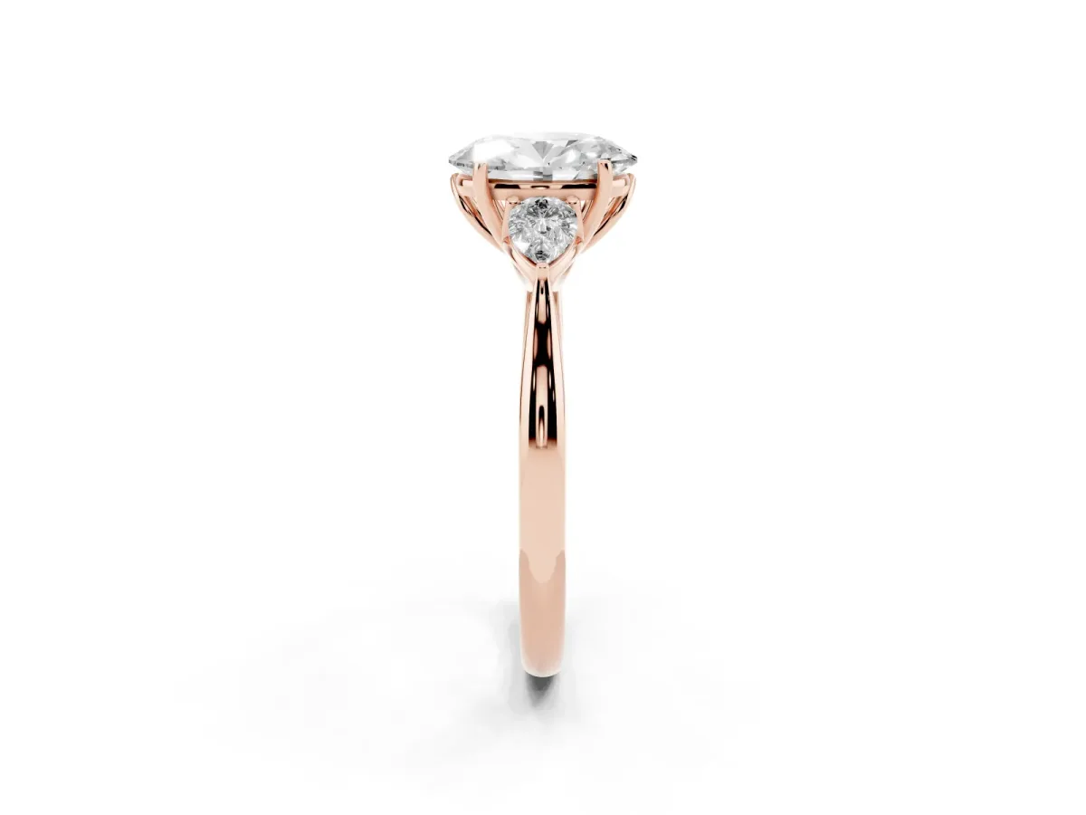 Three-Stone Oval Cut Diamond Ring with Pear Side Stones in Four-Prong Setting Rose gold