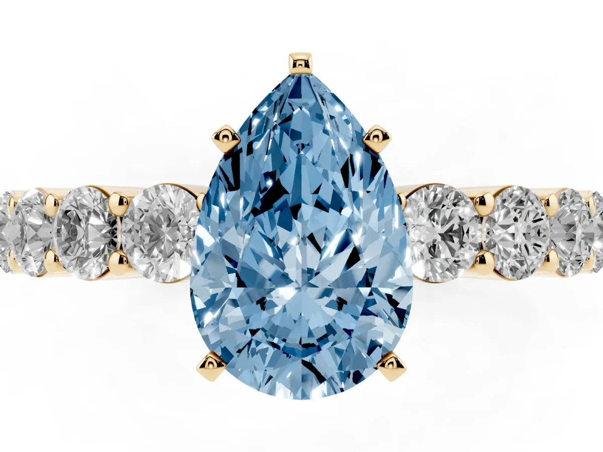 Fancy Blue Pear Cut Diamond Solitaire Ring with Shared Prong Round Side Stones Yellow gold