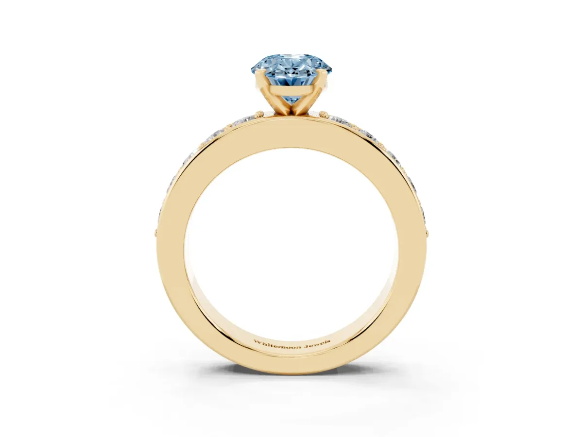 Fancy Blue Oval Cut Diamond Engagement Ring with Channel Set Round Band and Prong Setting Yellow gold