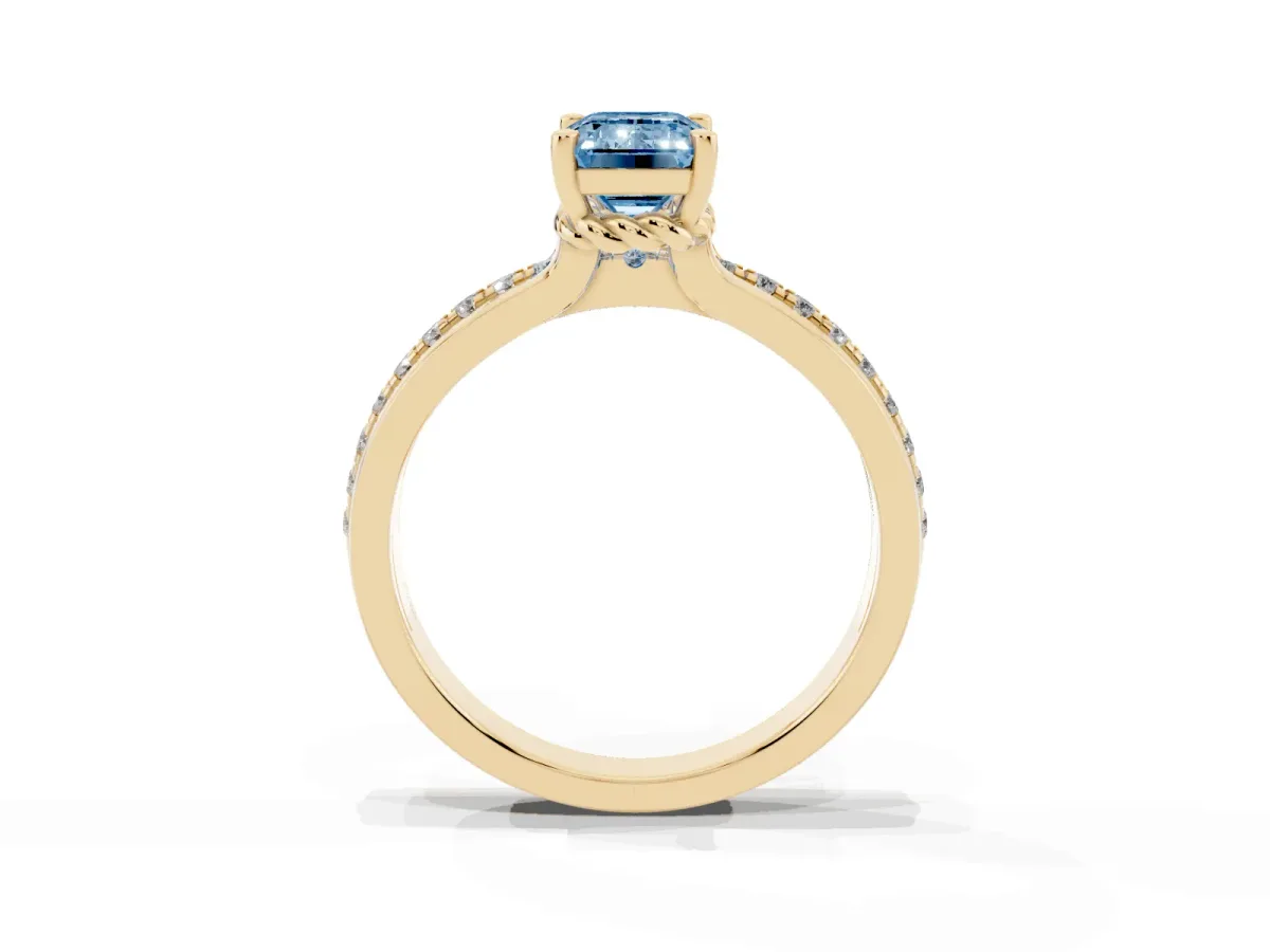 Fancy Blue Emerald Cut Solitaire Diamond Ring with Channel Set Band and Six-Prong Setting Yellow gold