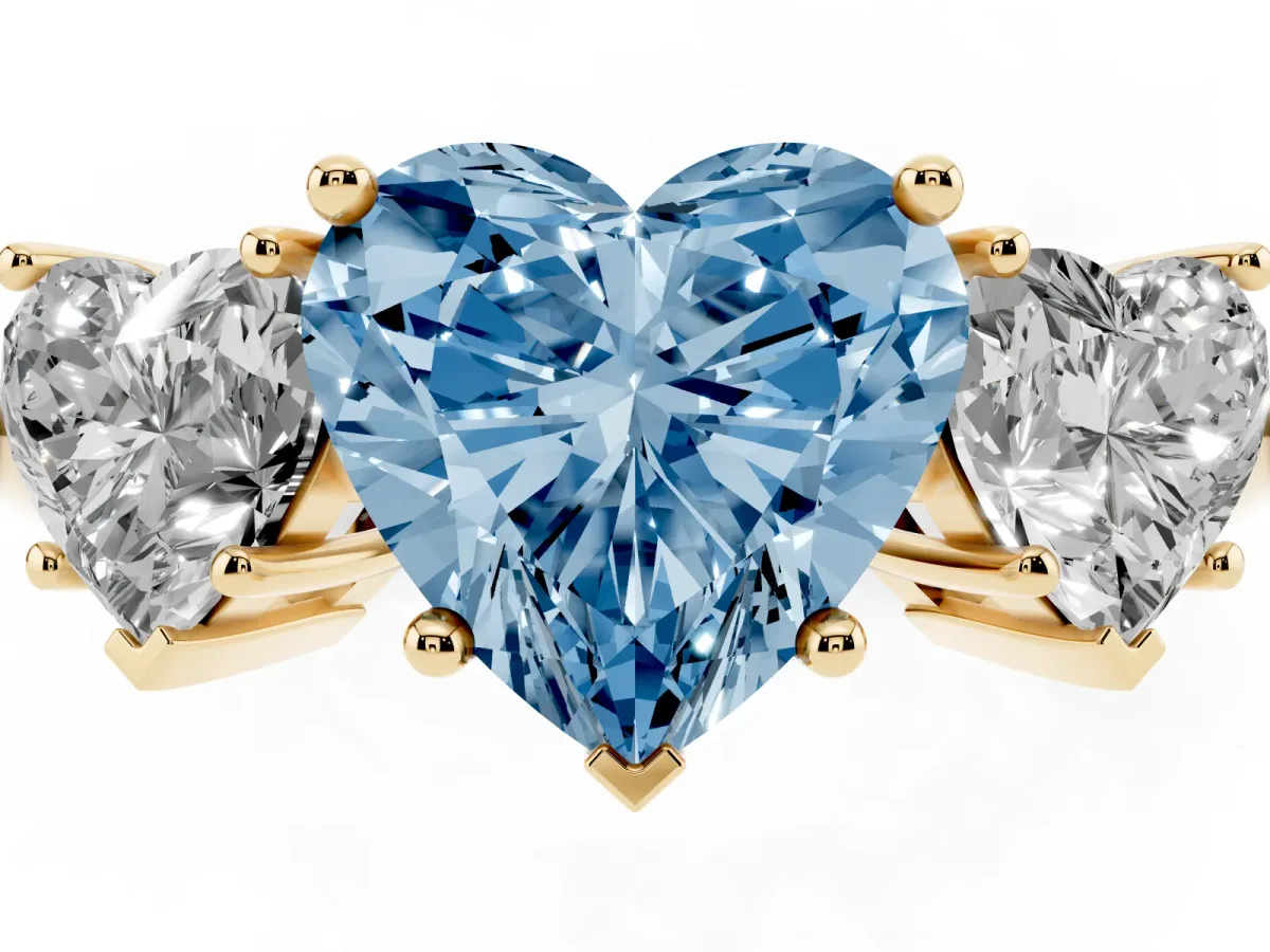 Fancy Blue Three-Stone Heart Cut Cut Diamond Engagement Ring with Prong Setting on a White Gold Band Yellow gold