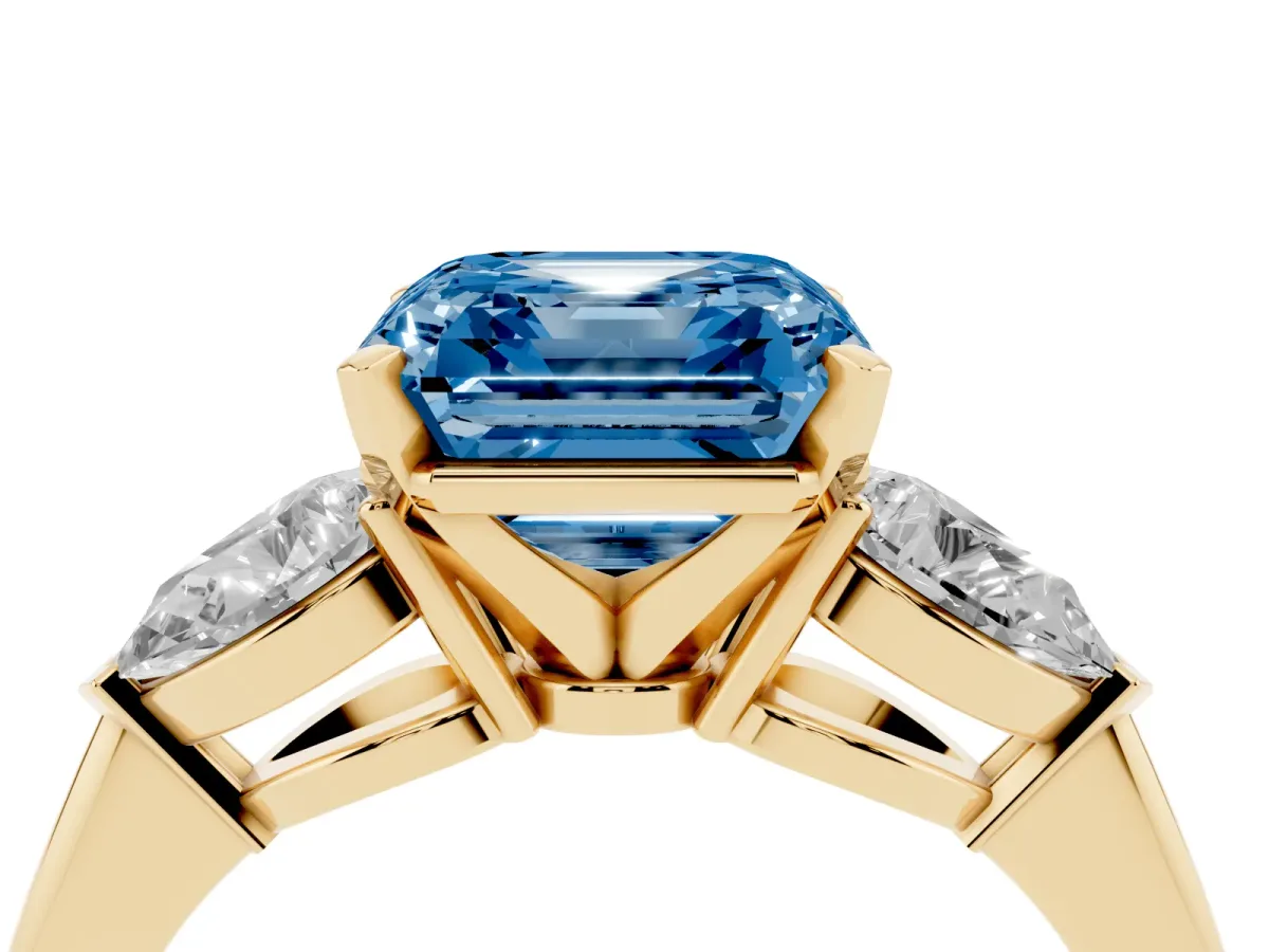 Fancy Blue Three-Stone Asscher Cut Diamond Ring with Pear Side Stones and Four-Prong Setting Yellow gold