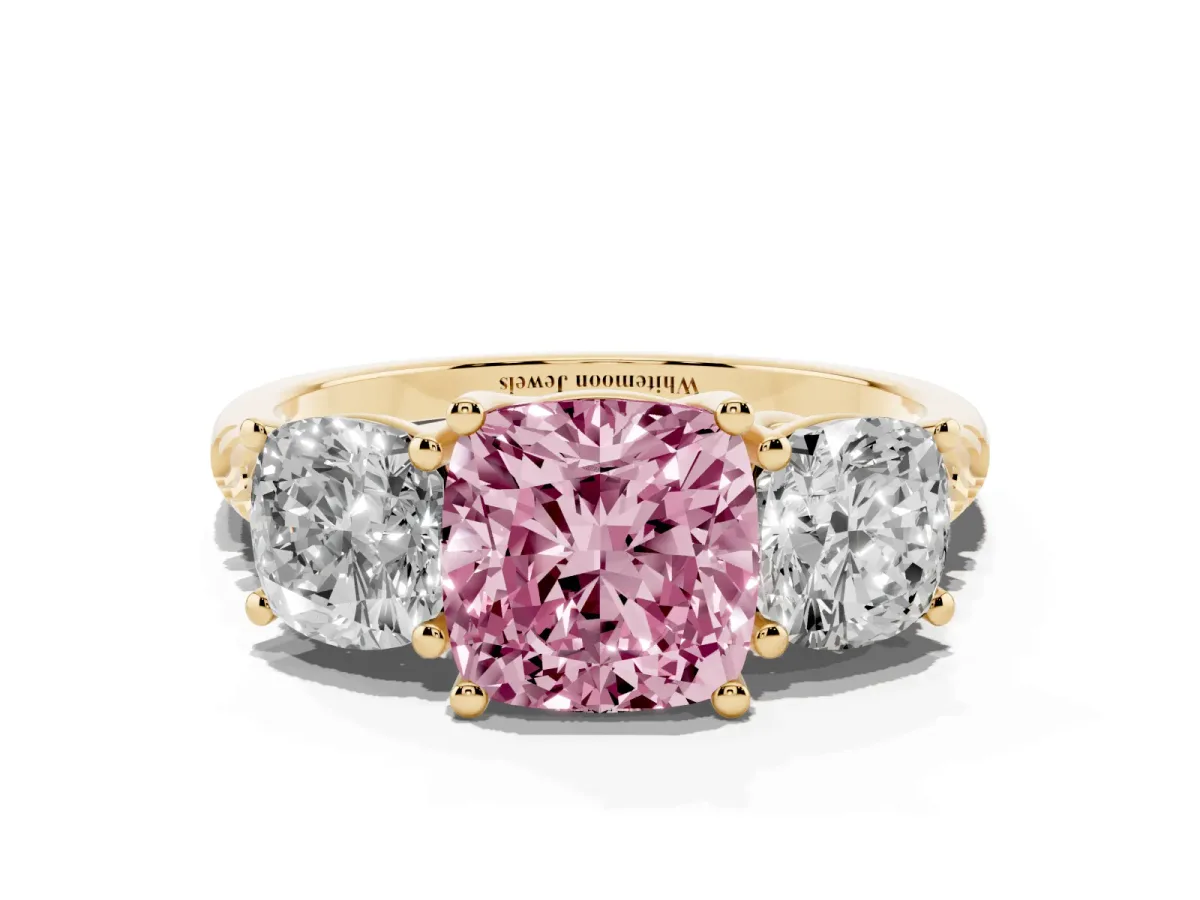 Fancy Pink Three-Stone Cushion Cut Diamond Ring with Round Pavé Band and Prong Setting Yellow gold