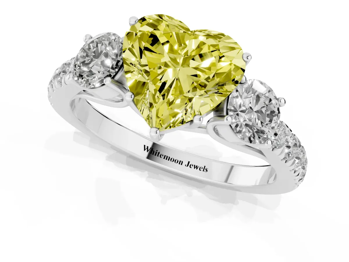 Fancy Yellow Heart Cut Cut Diamond Three-Stone Ring with Round Side Stones and Pavé Band Platinum