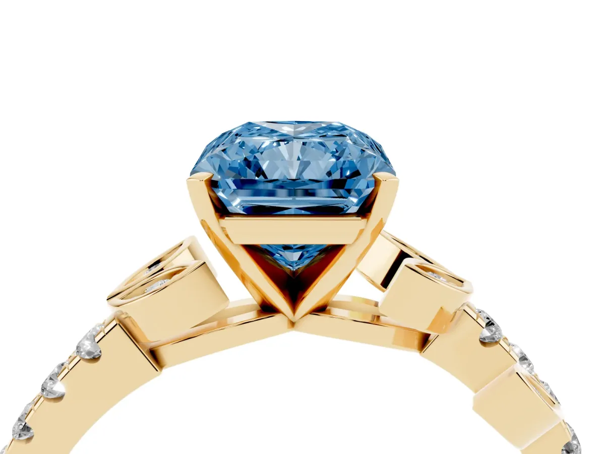 Fancy Blue Radiant Cut Solitaire Leaf-Inspired Diamond Ring with Pavé Band and Four-Prong Setting Yellow gold