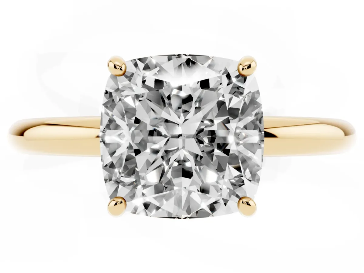 Cushion Cut Solitaire Diamond Ring with Four-Prong Setting on a Plain Band Yellow gold