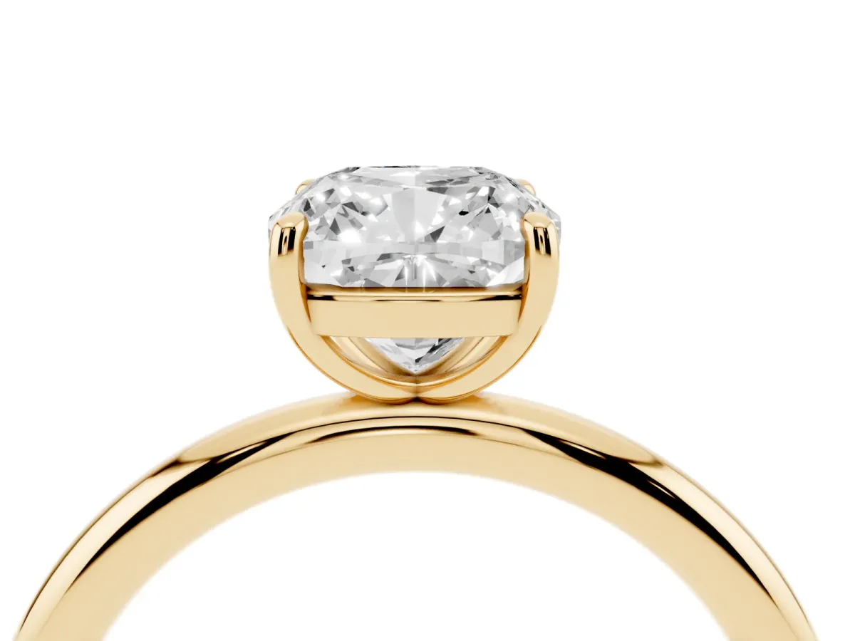 Cushion Cut Solitaire Diamond Ring with Four-Prong Setting on a Plain Band Yellow gold