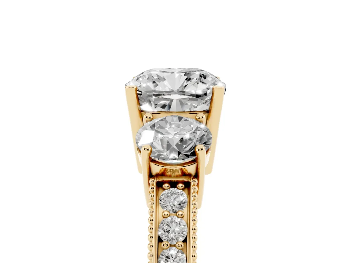 Cushion Cut Three-Stone Diamond Ring with Pavé Band and Four-Prong Setting Yellow gold
