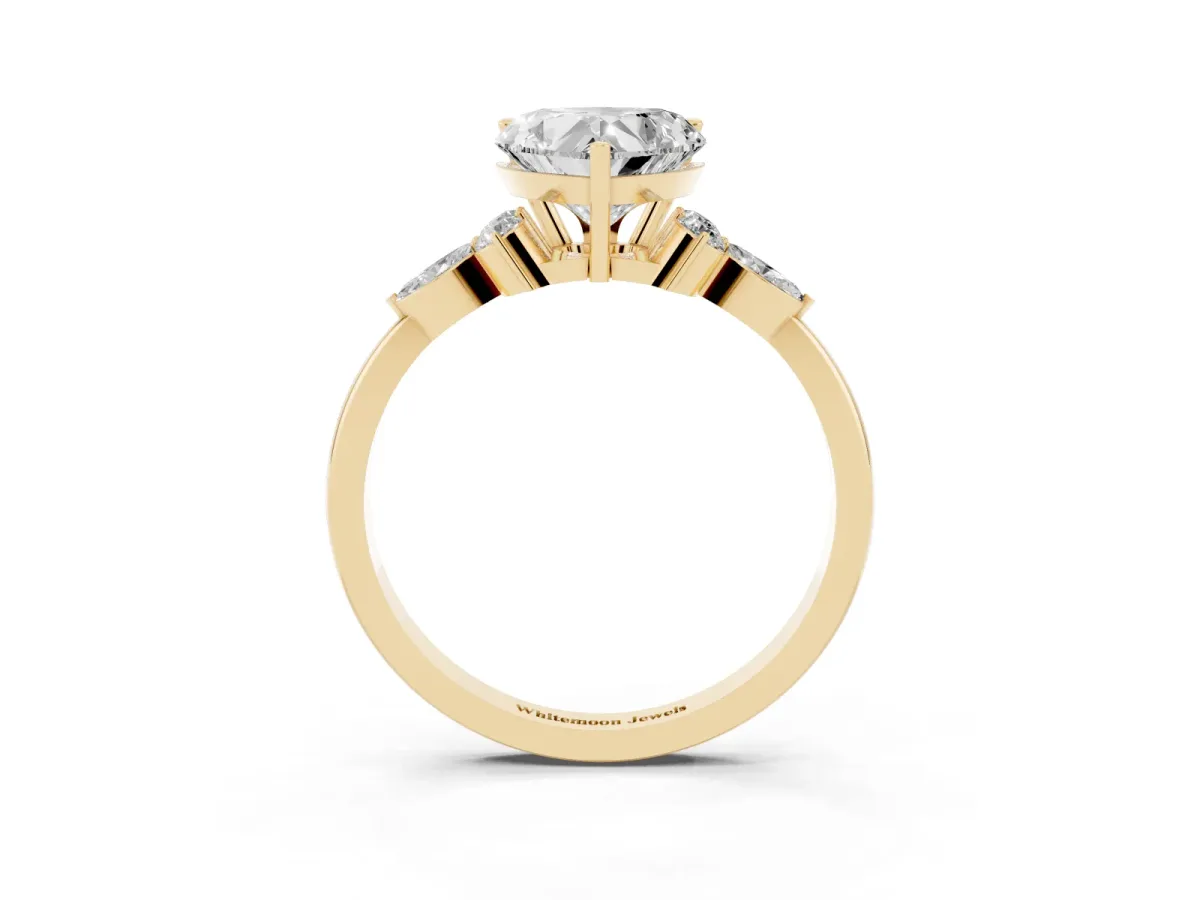 Heart Cut Brilliant Diamond Solitaire Ring with Pear Side Stones and Four-Prong Setting Yellow gold