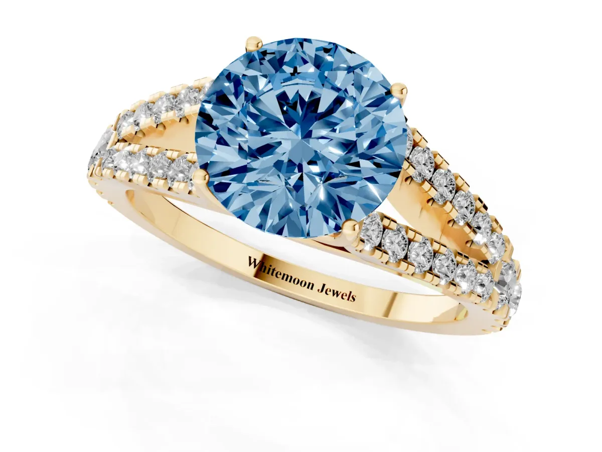 Fancy Blue Round Cut Diamond Split Shank Pavé Engagement Ring with Four-Prong Setting Yellow gold