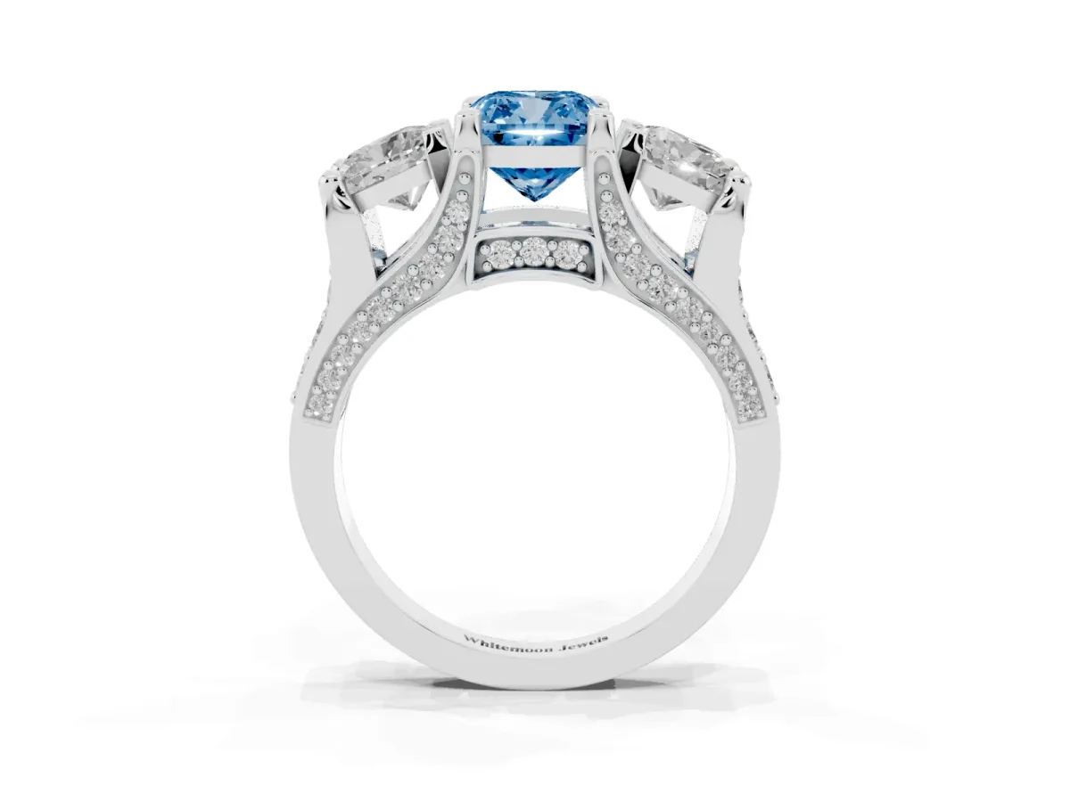 Fancy Blue Cushion Cut Diamond Three-Stone Ring with Channel Set Band and Four-Prong Setting Silver