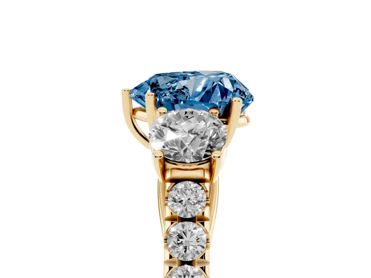 Fancy Blue Heart Cut Cut Diamond Three-Stone Ring with Round Side Stones and Pavé Band Yellow gold
