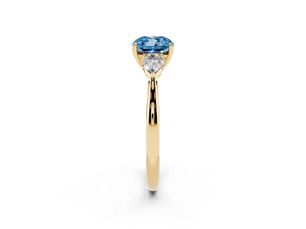 Fancy Blue Three-Stone Cushion Cut Brilliant Diamond Solitaire Ring with Tapered Band and Four-Prong Setting Yellow gold
