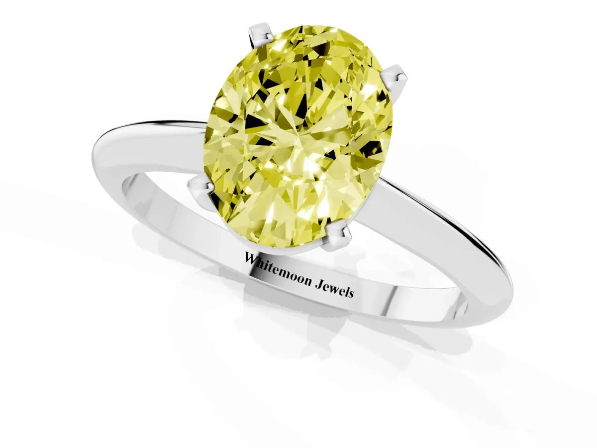 Fancy Yellow Oval Cut Cut Solitaire Ring with Four-Prong Setting on a Classic Band Platinum