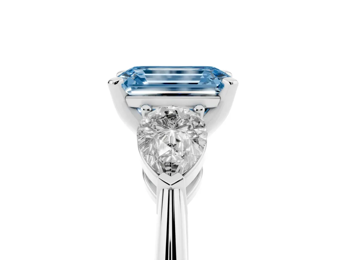 Fancy Blue Three-Stone Emerald Cut Diamond Ring with Pear Side Stones and Four-Prong Setting Platinum