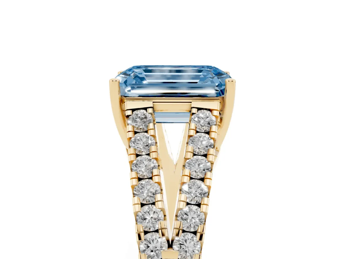 Fancy Blue Emerald Cut Diamond Split Shank Engagement Ring with Round Pavé and Prong Setting Yellow gold